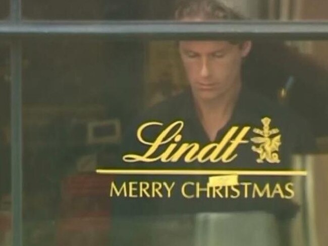 Lindt manager Tori Johnson at the window of the cafe during the siege. Picture: Channel 7