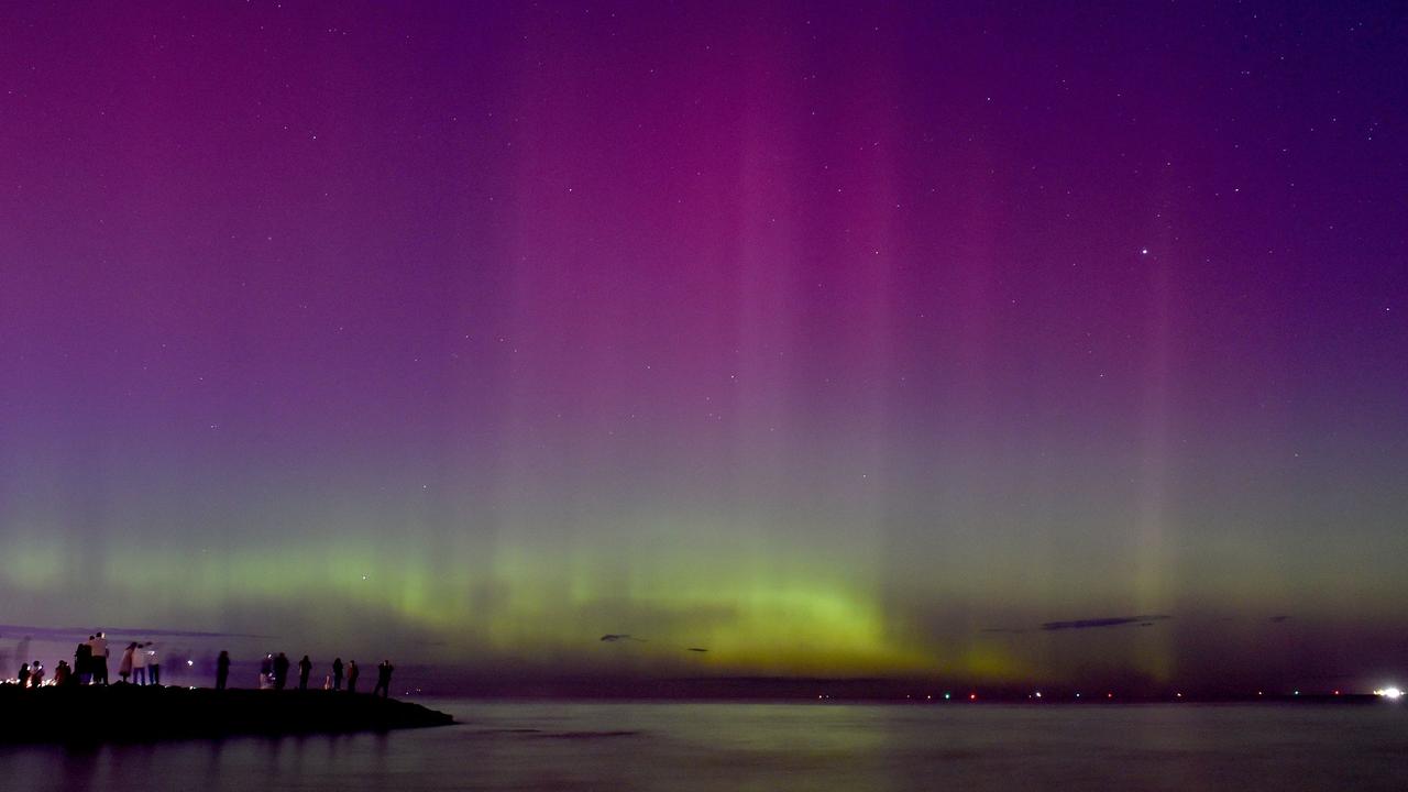 People watched the aurora australis at Port Phillip Bay in Melbourne in May. Picture: Paul Crock / AFP