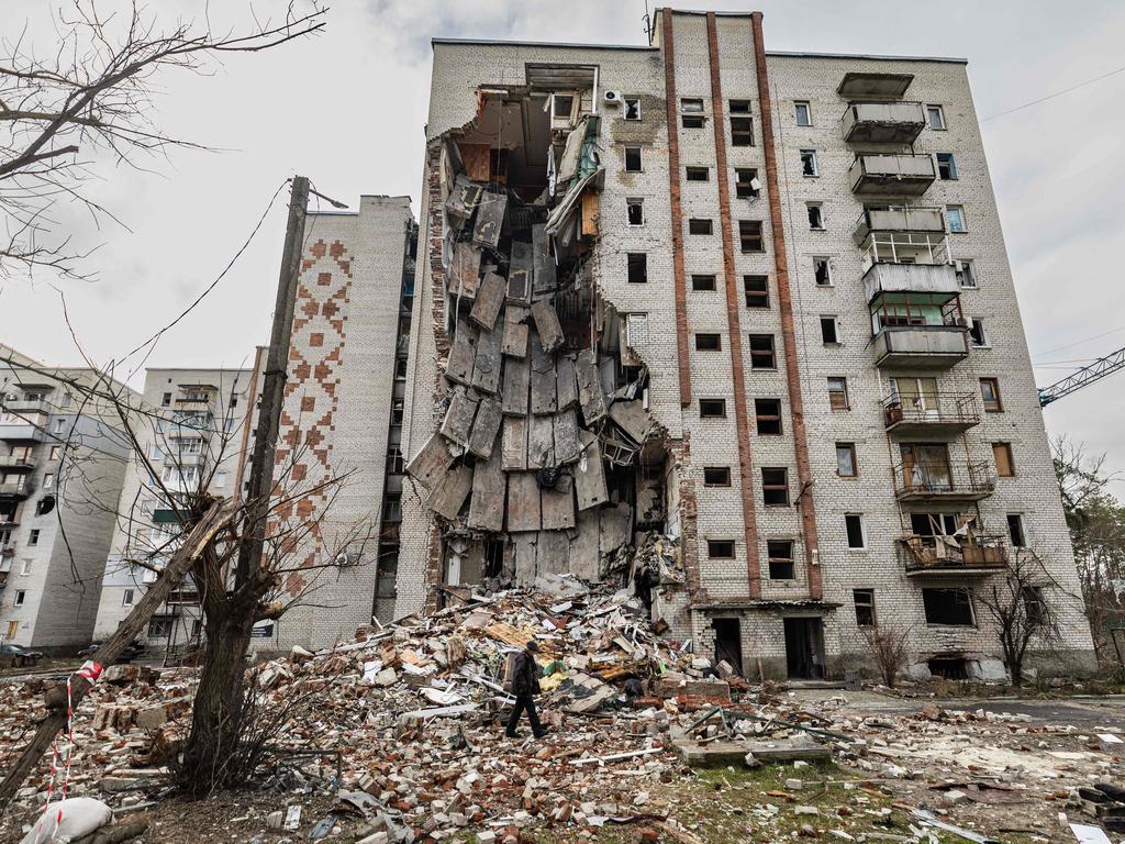 A resident walks next to a destroyed building in the city of Lyman, eastern Ukraine. Picture: AFP