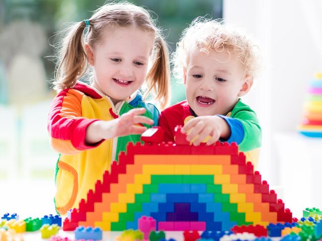 Child playing with colorful toys. Little girl and funny curly baby boy with educational toy blocks. Children play at day care or preschool. Mess in kids room. Toddlers build a tower in kindergarten. Picture: iStock