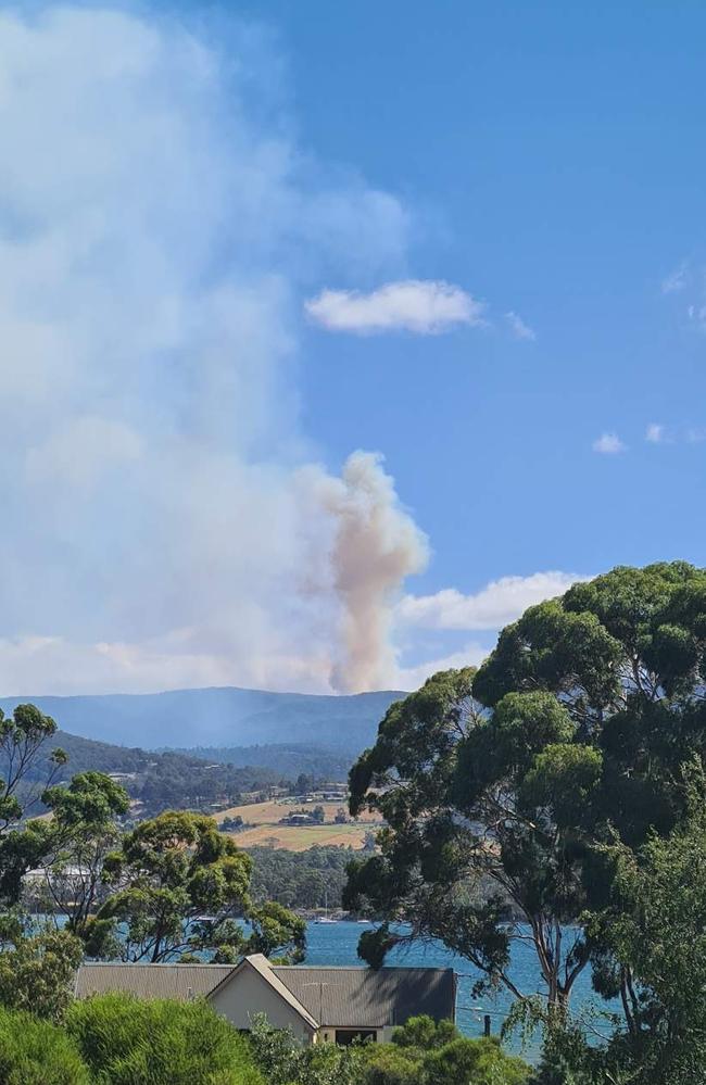 Smoke rises from a bushfire at Snug Tiers and Snug Falls, taken from Howden.