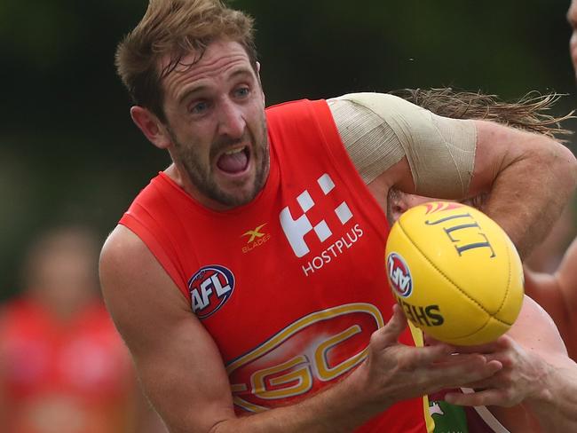 GOLD COAST, AUSTRALIA - FEBRUARY 19: Michael Barlow of the Suns is tackled during the 2017 JLT Community Series match at Broadbeach Sports Centre on February 19, 2017 in Gold Coast, Australia. (Photo by Chris Hyde/Getty Images)