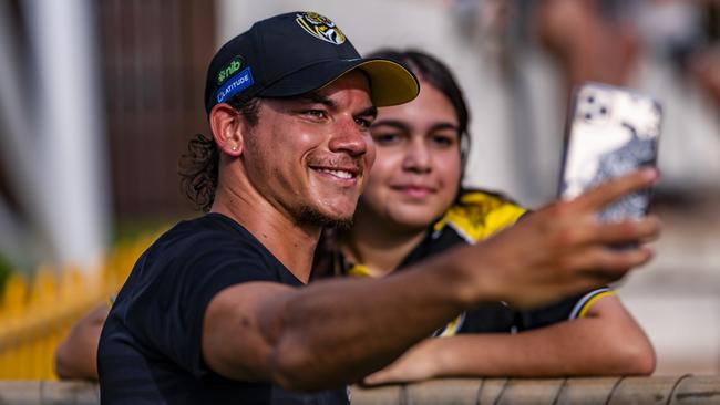 Hometown hero Daniel Rioli snapped a selfie with a fan after Richmond's open training run at TIO Stadium. Picture: Patch Clapp // AFLNT Media.