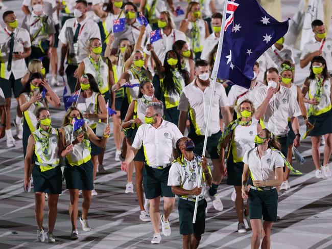 TOKYO, JAPAN - JULY 23: Flag bearers Cate Campbell and Patty Mills of Team Australia lead their team in during the Opening Ceremony of the Tokyo 2020 Olympic Games at Olympic Stadium on July 23, 2021 in Tokyo, Japan. (Photo by Patrick Smith/Getty Images)