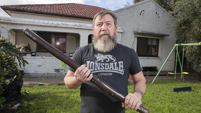 Kym Abrook with the didgeridoo he used to chase off a home invader last night. Picture: Simon Cross