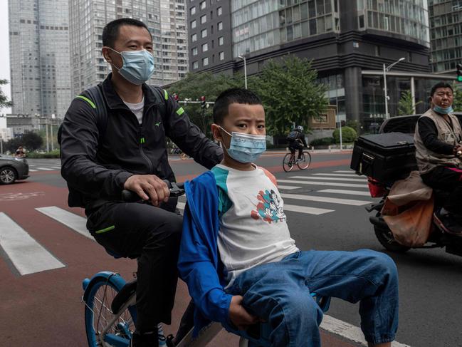 Commuters on a street in Beijing on Monday. Picture: AFP