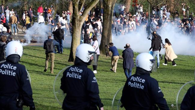 Belgian police officers surround bystanders at the Bois de la Cambre park in Brussels. Picture: AFP