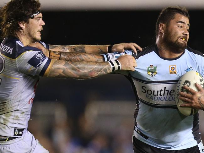 Andrew Fifita of the Sharks (right) fends off a tackle from Ethan Lowe of the Cowboys during the round 14 NRL match between the Cronulla-Sutherland Sharks and the North Queensland Cowboys at Southern Cross Group Stadium in Sydney on Monday, June 13, 2016. (AAP Image/Craig Golding) NO ARCHIVING, EDITORIAL USE ONLY