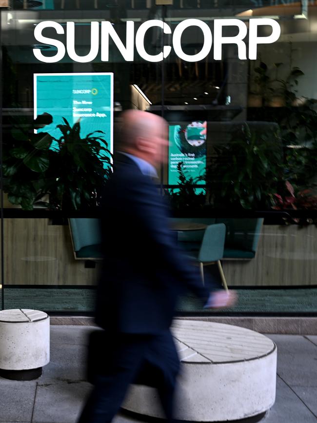 People walk past a Suncorp Bank branch in Brisbane.