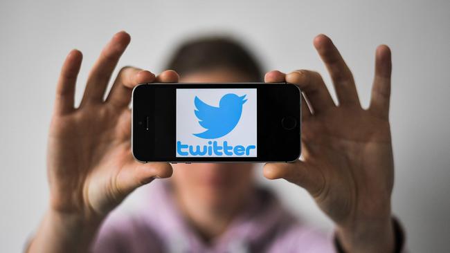 A woman holds a smartphone with the logo of US social network Twitter, on May 2, 2019 in Nantes, western France. (Photo by LOIC VENANCE / AFP)