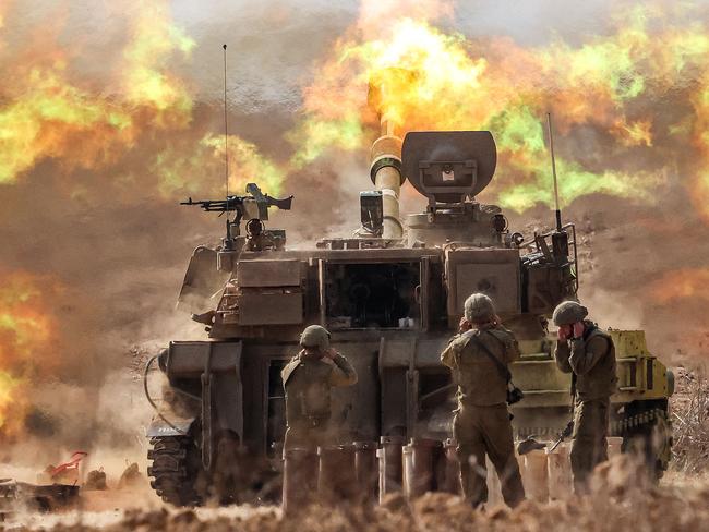 An Israeli army self-propelled howitzer fires rounds near the border with Gaza.