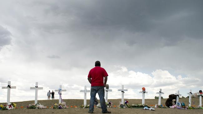 A man pauses at a memorial near the Century 16 movie theatre in Aurora, Colorado. Picture: Dom Emmert