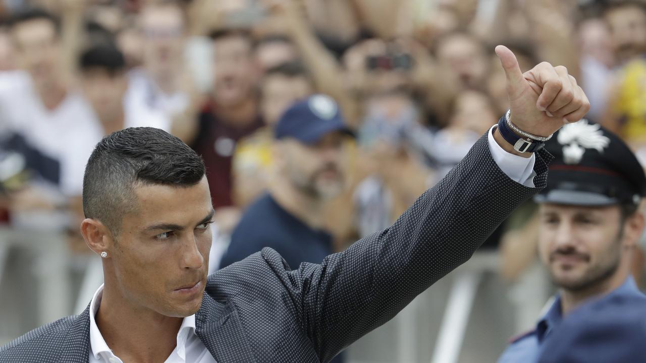 Portuguese ace Ronaldo gives the thumb-up sign as he arrives to undergo medical checks at the Juventus stadium in Turin