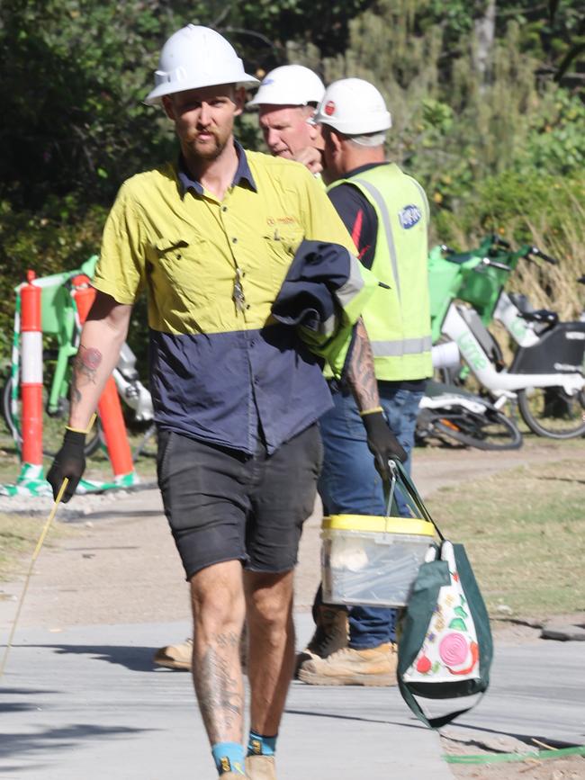 Builders collecting tools and equipment , being watched by security, and leaving the Midwater building site at Main Beach. Picture Glenn Hampson