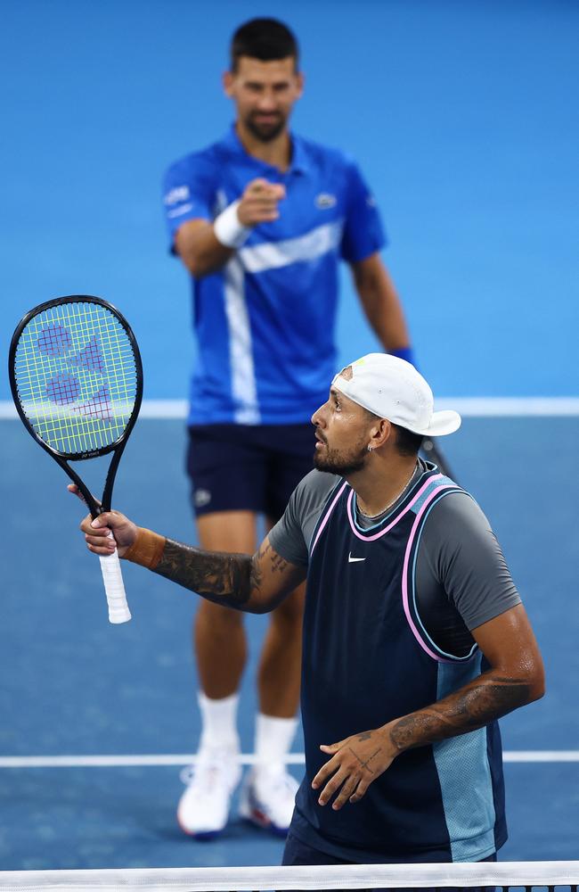 Novak Djokovic and Nick Kyrgios celebrate a point.