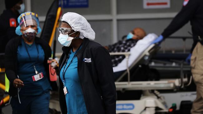 Medical workers take in patients at a special coronavirus intake area at Maimonides Medical Center. Hospitals in New York City, which has been especially hard hit by the coronavirus, are facing shortages of beds, ventilators and protective equipment for medical staff.