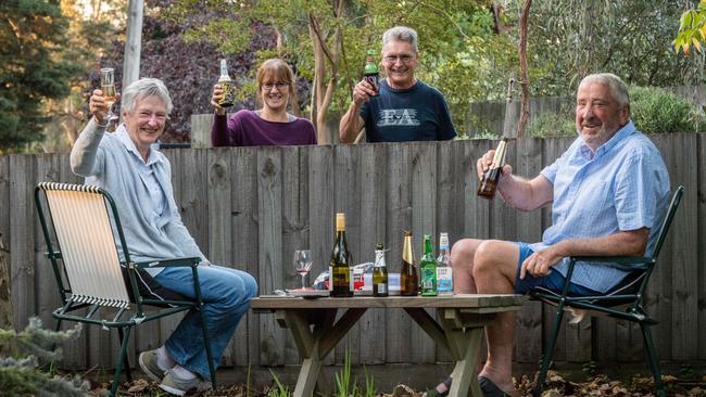 Neighbours Bruce and Janine Deith share a drink with Wendy and Ian mills while adhering to social distancing rules. Picture: Jake Nowakowski