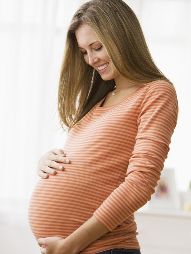 Beautiful young pregnant woman smiling