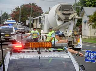 Sergeant Jarrod French of Coffs Clarence Highway patrol directs drivers in for Random Breath Testing at Ulmarra. Picture: Adam Hourigan Photography