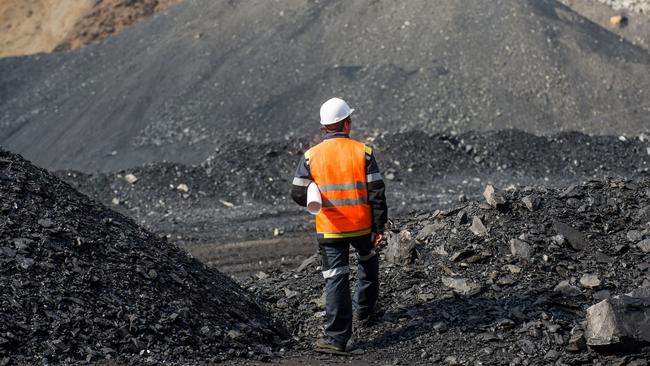 Coal mining in an open pit — Worker is looking on the huge open pit.