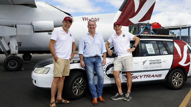 Retired pilots and next door neighbours Rolly Griffin and Bruce Milne have entered the Shitbox Rally and will fundraise for the Cancer Council by driving a $600 Holden Commodore from Mackay to Darwin. Local aviation company Skytrans is sponsoring the pair who will complete the rally over 7 days. Rolly Griffin, Skytrans CEO Alan Milne and Bruce Milne. Picture: Brendan Radke