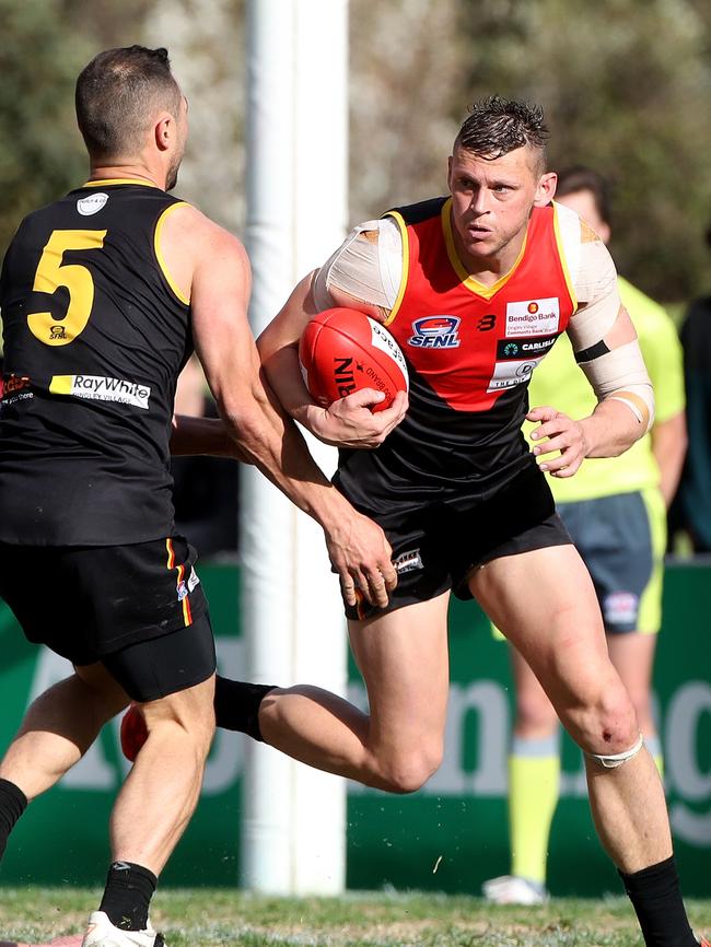 Danny Ades runs the ball out of defence in last year’s grand final.