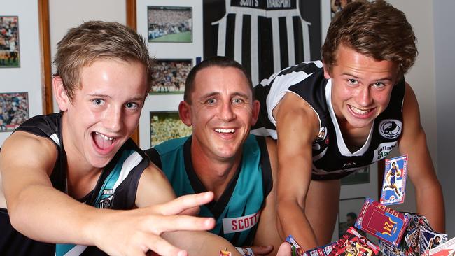 Jackson Mead (left) as a 12-year-old alongside his Port Adelaide best and fairest winning dad Darren Mead, and older brother Mitchell. Picture: Sarah Reed