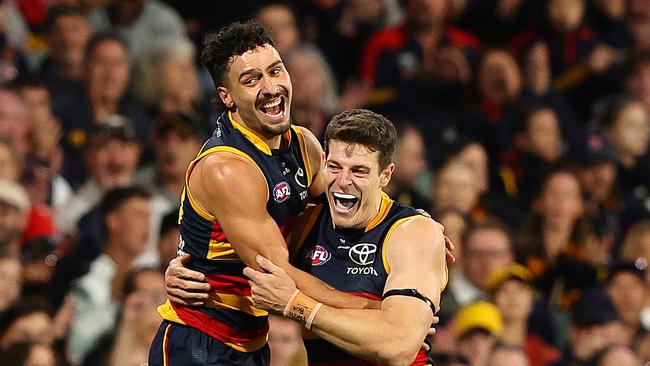 ADELAIDE, AUSTRALIA - MARCH 22: Chris Burgess of the Crows celebrates a goal with Izak Rankine . (Photo by Sarah Reed/AFL Photos via Getty Images)