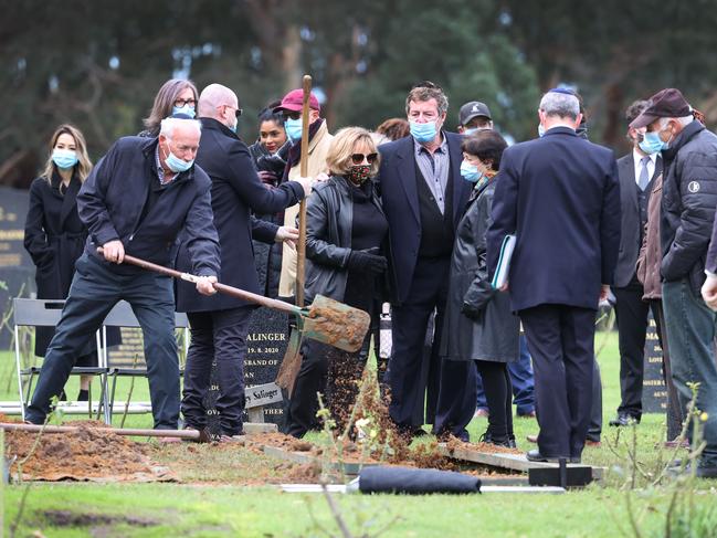 Mourners pay their respects. Picture: David Caird