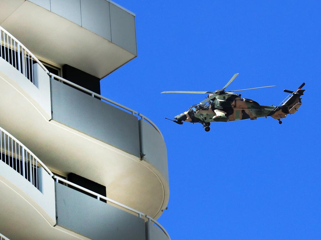 A military helicopter patrols the Queensland-NSW border on the Gold Coast on Thursday. Picture: Scott Powick