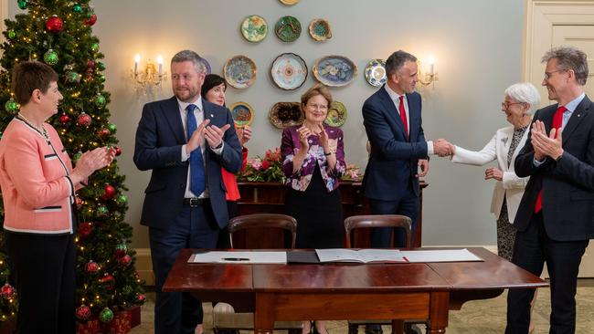 Applauding the signing of university merger documents at Government House last December are (L-R) UniSA chancellor Pauline Carr, UniSA vice-chancellor David Lloyd, Deputy Premier Susan Close, Governor Frances Adamson, Premier Peter Malinauskas, University of Adelaide chancellor Catherine Branson and University of Adelaide vice-chancellor Peter Hoj. Picture: Naomi Jellicoe