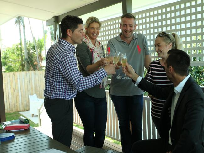 Place directors Brad Robson and Peter May with the new owner of 240 Long St East, Graceville celebrating with sellers Heidi Trevaskis and her husband Carl. Photo: Supplied