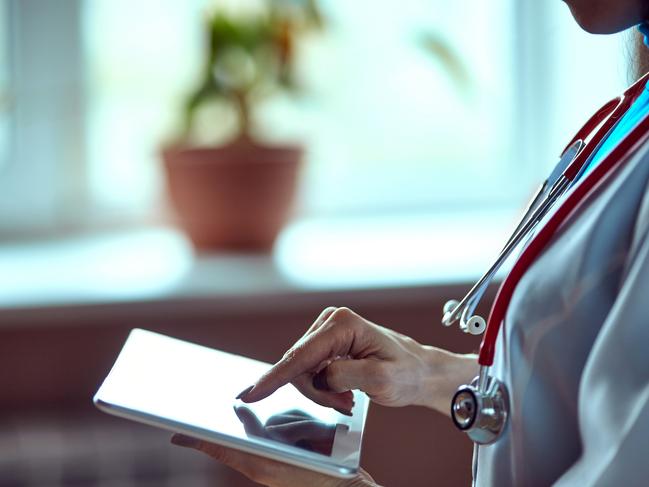 Woman doctor using tablet computer in hospital