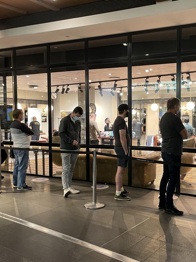 A line at Barber Industries, Charlestown Square shopping centre, on Monday morning, with retail reopening to trade out of lockdown. Picture: Amy Ziniak