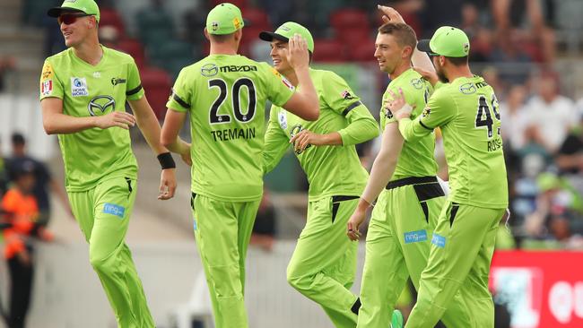 Daniel Sams (second from right) celebrates with his Sydney Thunder teammates after taking the wicket of Striker Phil Salt in Canberra on Saturday night. Picture: Brendon Thorne/Getty Images