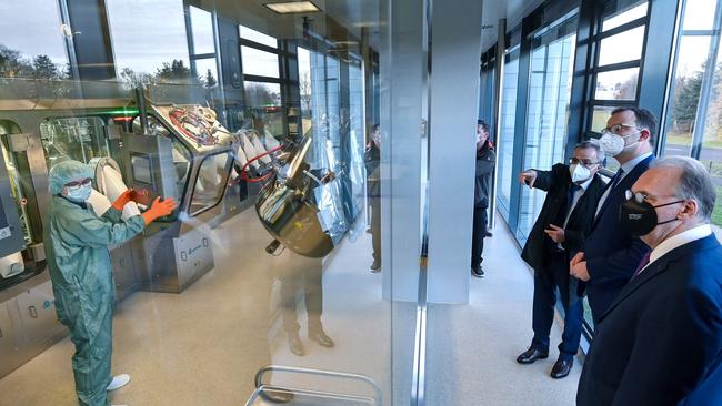 German Health Minister Jens Spahn (C) and Saxony-Anhalt's State Premier Reiner Haseloff (R), are shown around vaccine production company IDT Biologika. Picture: AFP.