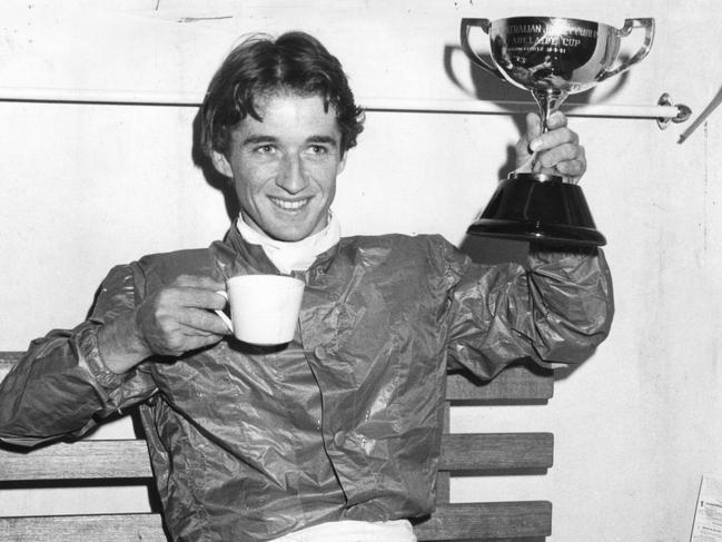 Jockey Malcolm Johnston holds aloft the trophy after winning the Adelaide Cup on Just A Dash at Morphettville Racecourse, 18 May 1981. (Pic by unidentified staff photographer)