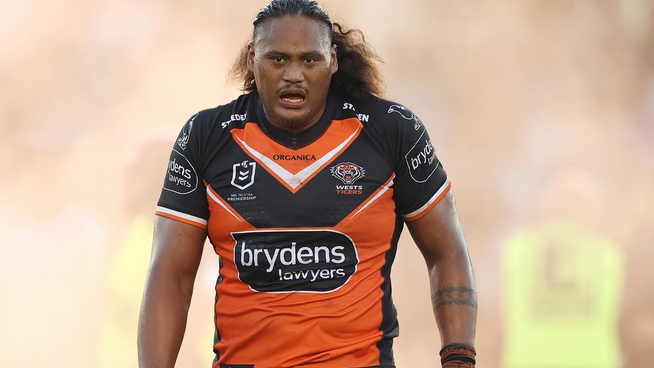 SYDNEY, AUSTRALIA - APRIL 10: Luciano Leilua of the Tigers looks as as smoke from a flare is seen on the field after a pitch invader ran onto the field with a flare during the round five NRL match between the Cronulla Sharks and the Wests Tigers at PointsBet Stadium, on April 10, 2022, in Sydney, Australia. (Photo by Mark Kolbe/Getty Images)