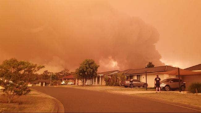 Bushfires burning near homes in Crowdy Bay, NSW.