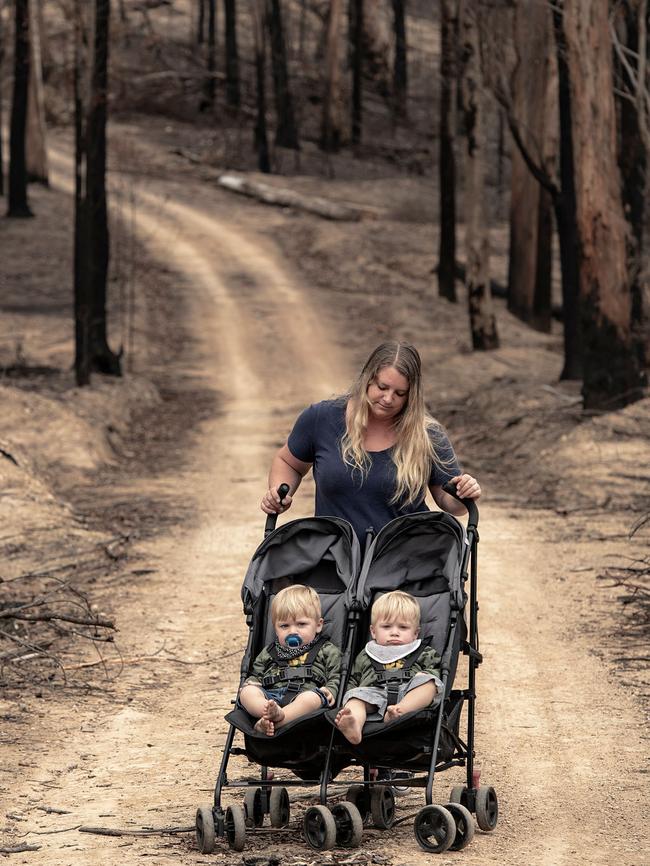 AUS MAG. Portrait of Therese McGovern with her identical twins Artie and Alby. Photographed on her drive way in Upper Kiah near the Mount Imlay national park. She has 6 children and has lived in Kiah all her life. Her husband stayed during the fires on new years day 2020 and saved their house. Her father who is 2nd generation fire fighter lost his houase next door. She lost the 7 different houses in the valley that she grew up in. Pic by Nic Walker. For a story by Trent Dalton. Date 16th Feb 2019