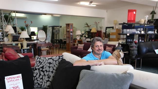 Scottys Trading Post sells furniture, electrical goods and whiteware. Owner Murray Alderson relaxes on the couch at the new Bundall store. Picture: Glenn Hampson