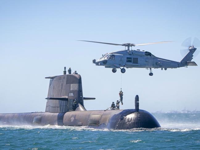 HMAS Rankin conducts helicopter transfers in Cockburn Sound, Western Australia, as part of Rankin's training assessments to ensure the boat is ready to deploy. *** Local Caption *** HMAS Rankin and her crew conducted workups and training assessments in the Western Australian Exercise Area to ensure the Collins Class Submarine is ready to safely deploy later in the year.   Part of her assessment is helicopter transfers which ensures the crew are able to winch personnel on or off in the case of an emergency.