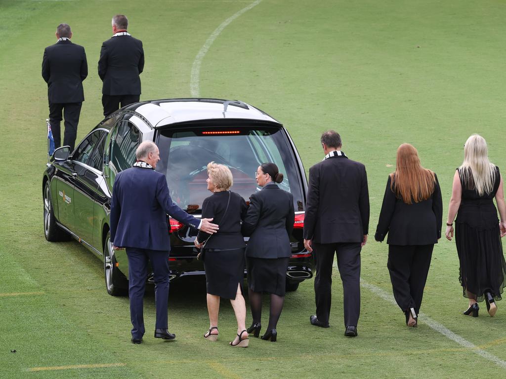 Family and friends follow the hearse carrying Warne’s coffin for a lap of the ground. Picture: David Caird