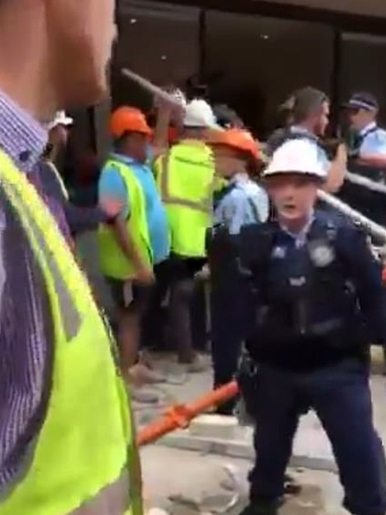 Tradies can be seen arguing with police officers. Picture: Facebook/Mo Laalaa