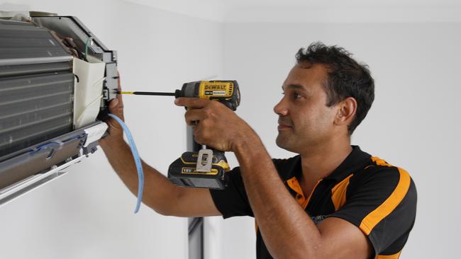 Refrigeration and airconditioning technician Ben Wone installs an air conditioner in a new home in Kamerunga PICTURE: ANNA ROGERS