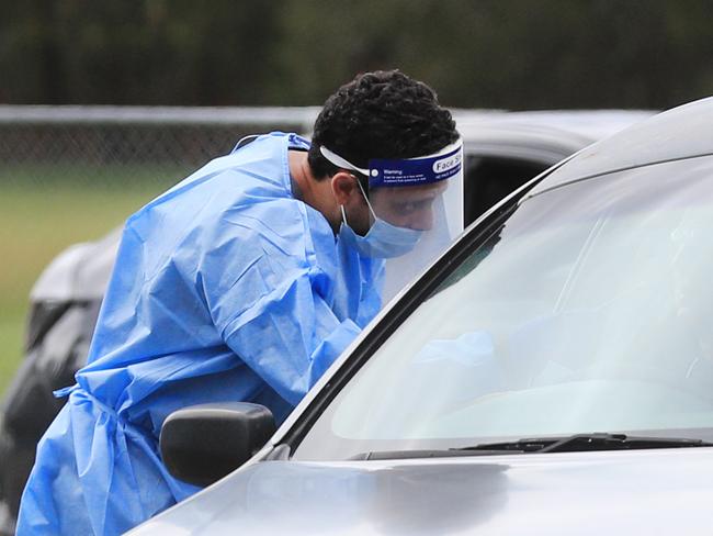 CURRUMBIN , AUSTRALIA - NewsWire Photos March 31, 2021: QML Pathology staff test Gold Coast locals who have to wait hours to be tested for Covid-19 at the Currumbin Eagles Rugby League Club which has turned into a Pop Up Testing.Picture: NCA NewsWire / Scott Powick