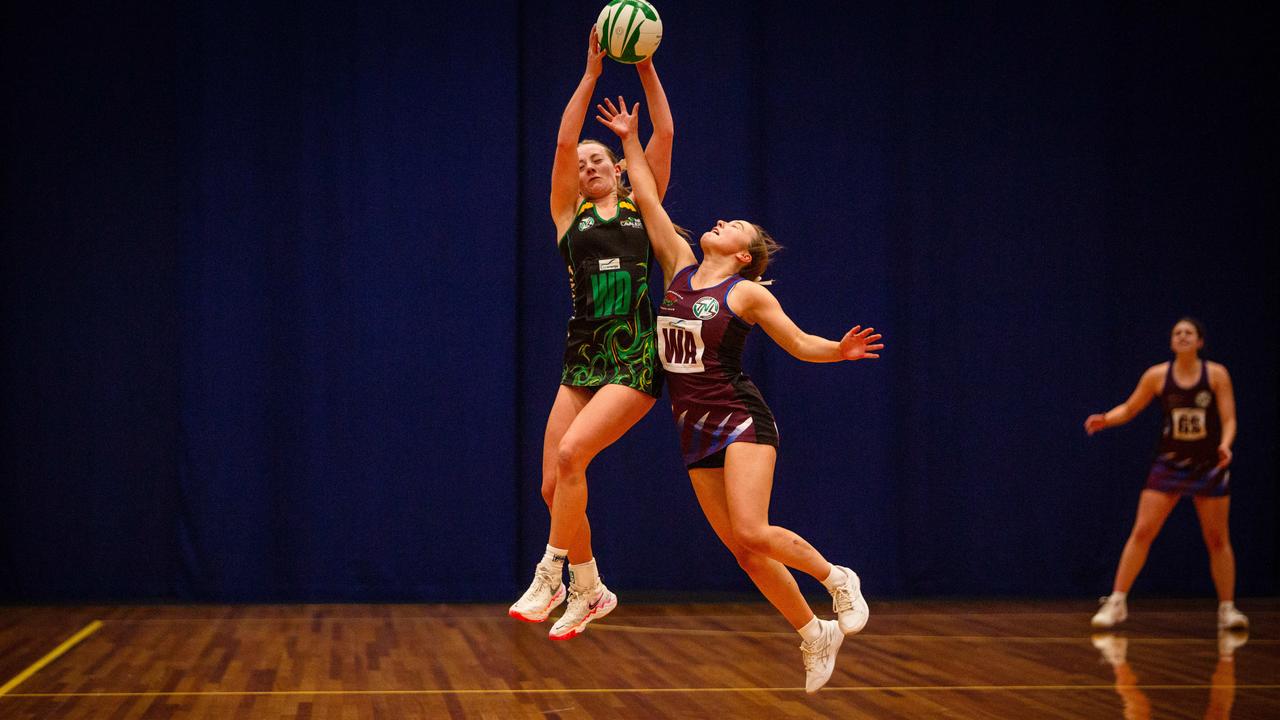 Cavaliers wing defence Asha Lowe and Cripps wing attack Maya Armstrong clash in the air in the U19 state netball grand final at Launceston's Silverdome. Picture: PATRICK GEE/SUPPLIED