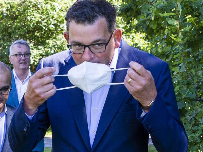 MELBOURNE, AUSTRALIA - NewsWire Photos February 17, 2022: (L-R) Victorian Premier Daniel Andrews puts on a mask after a press conference with Deputy Premier, James Merlino and Minister for Health, Martin Foley. Picture: NCA NewsWire / Aaron Francis