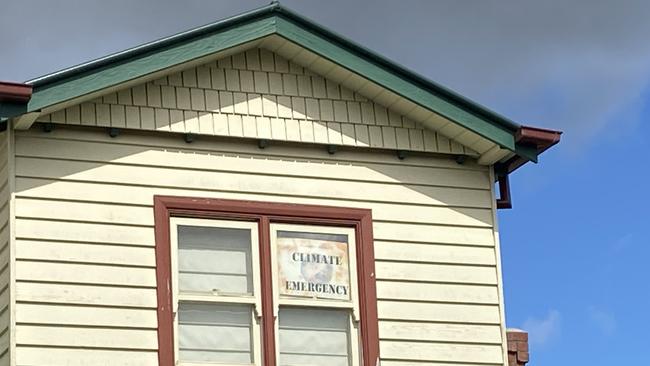 A ‘climate emergency' sign in Preston house window. Picture: Kirra Grimes