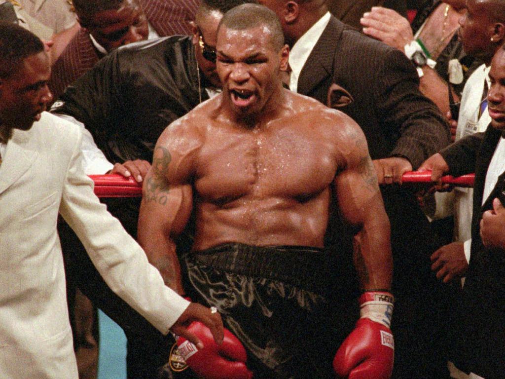 Mike Tyson reacts to the crowd as he leaves the ring after being disqualified in his bout with WBA heavyweight champion Evander Holyfield in 1997.